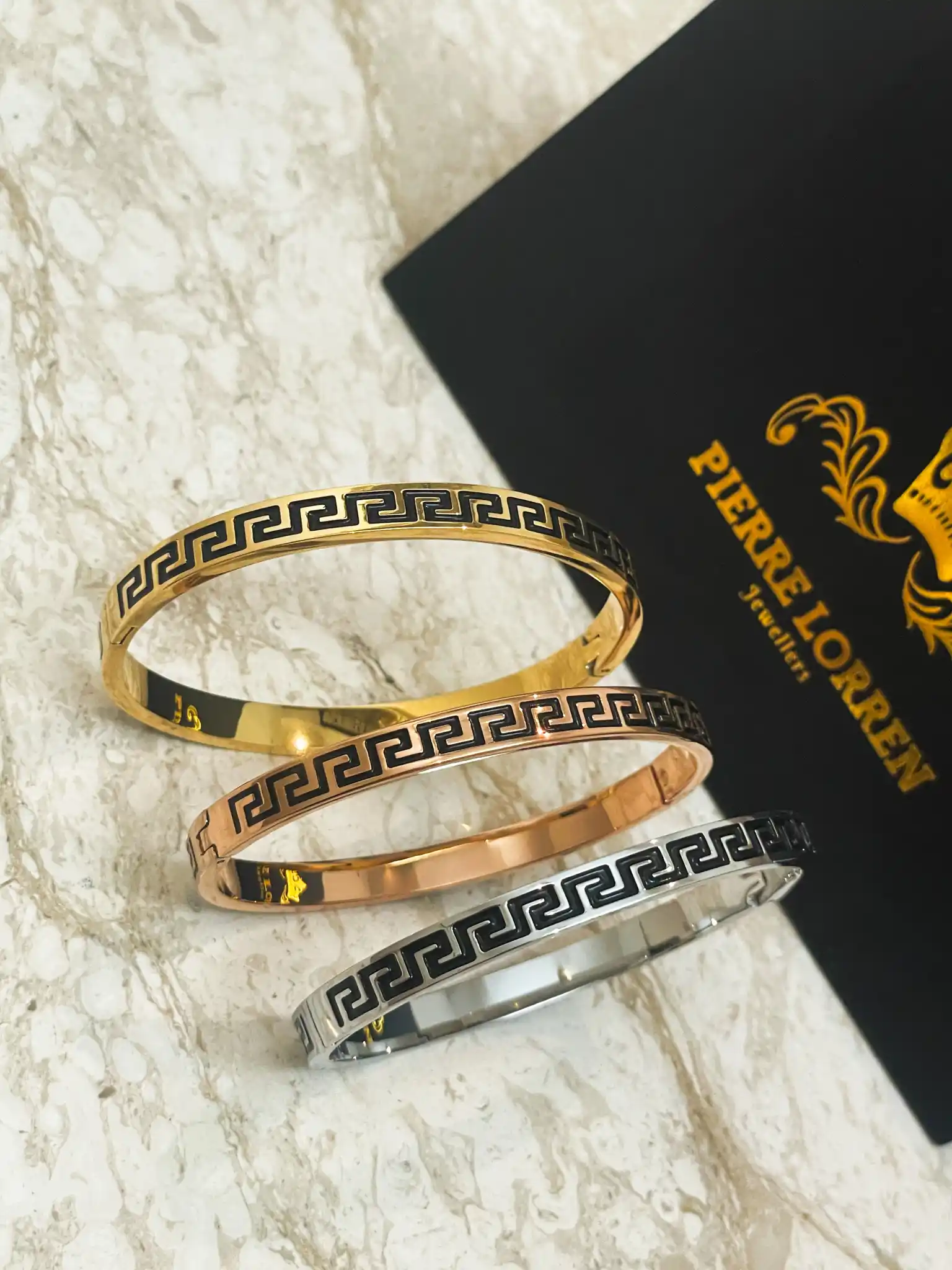 3 x Meander Bracelets - 8mm Greek Key Bangle HANDMADE Jewelry Gift Infinity Bangle Bracelet Greek Jewelry for Women Graduation Success HANDMADE by Pierre Lorren

🏺Handmade by our in-house master jewelers in Cyprus—on the island of beauty and love, Aphrodite

🏺 Vermeil-style 18K gold over sterling silver for a warm, opulent sheen

🏺 The 8 mm broad Greek Key/Mander motif represents harmony, eternity, wealth, and endless life.

🏺 Stylish clip/box fastening for a snug, cozy fit

🏺 Classic geometric style that enhances both special occasion and daily ensembles

sharp lines, a high-gloss finish, and painstaking, handmade workmanship

🏺 A thoughtful present for milestones, anniversaries, Christmas, New Year's, and birthdays

🏺 Present-ready: comes with a certificate of authenticity and in a Pierre Lorren box and bag.

🏺 Versatile styling: looks great with gold or silver pieces and stacks with bangles.

🏺 Skin-friendly and nickel-free materials for comfortable daily use in 