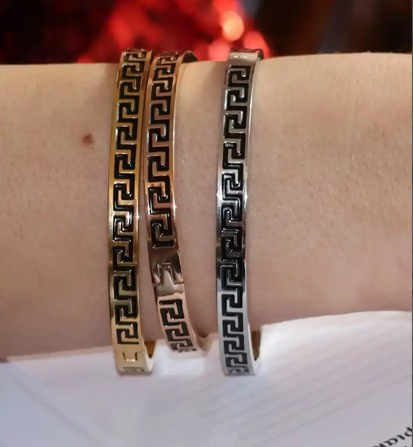 3 x Meander Bracelets - 8mm Greek Key Bangle HANDMADE Jewelry Gift Infinity Bangle Bracelet Greek Jewelry for Women Graduation Success HANDMADE by Pierre Lorren

🏺Handmade by our in-house master jewelers in Cyprus—on the island of beauty and love, Aphrodite

🏺 Vermeil-style 18K gold over sterling silver for a warm, opulent sheen

🏺 The 8 mm broad Greek Key/Mander motif represents harmony, eternity, wealth, and endless life.

🏺 Stylish clip/box fastening for a snug, cozy fit

🏺 Classic geometric style that enhances both special occasion and daily ensembles

sharp lines, a high-gloss finish, and painstaking, handmade workmanship

🏺 A thoughtful present for milestones, anniversaries, Christmas, New Year's, and birthdays

🏺 Present-ready: comes with a certificate of authenticity and in a Pierre Lorren box and bag.

🏺 Versatile styling: looks great with gold or silver pieces and stacks with bangles.

🏺 Skin-friendly and nickel-free materials for comfortable daily use in 